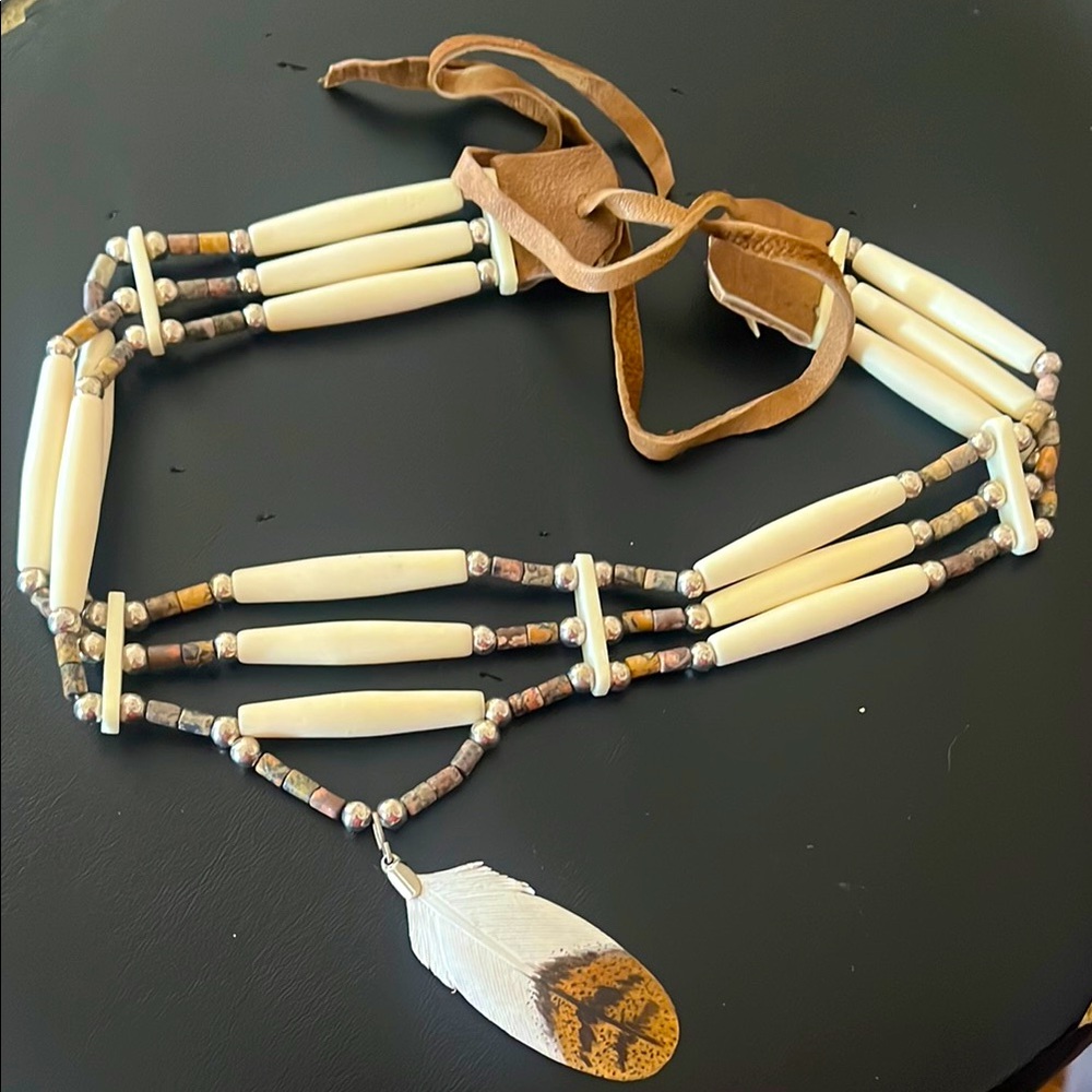 Artisan-made bone necklace with feather detail